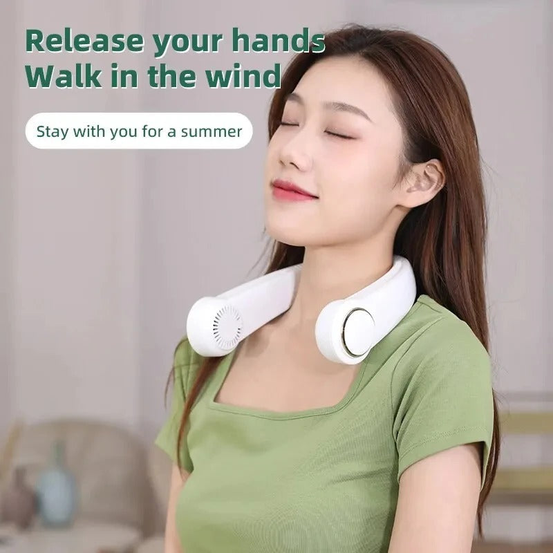 Person wearing the Arctic Air neck fan indoors, demonstrating hands-free cooling while working.